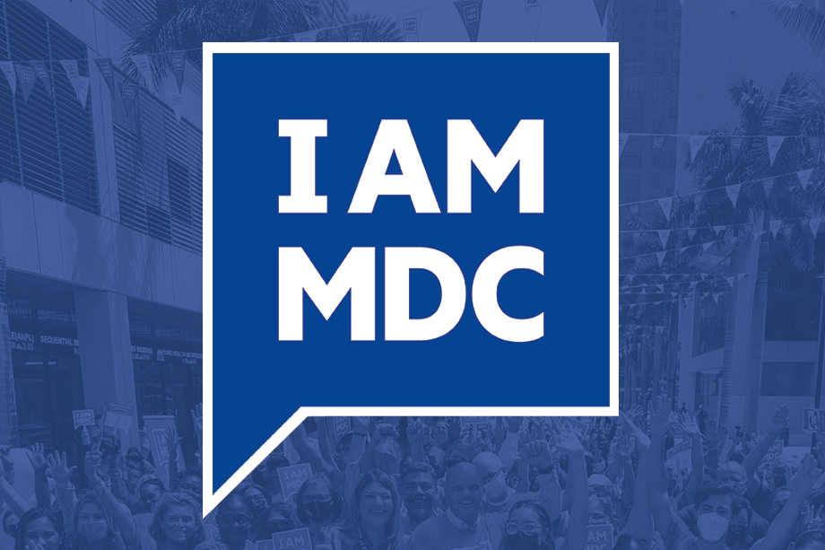 Finn, the shark mascot, posing with a student